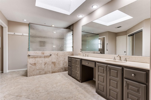 1504 Huron Trl, Plano, TX 75075 - bathroom featuring a skylight, a shower with shower door, double vanity, and recessed lighting