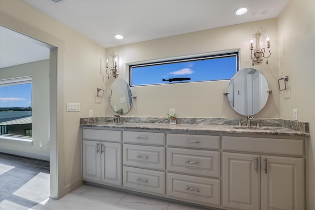 523 Contour Dr, Granite Shoals, TX 78654 - bathroom with double vanity, baseboards, and recessed lighting