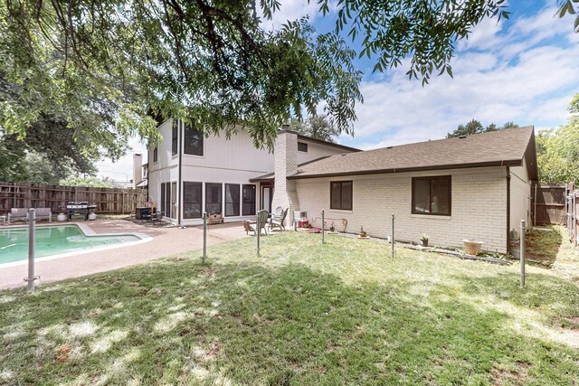 2003 Quincy Ct, Arlington, TX 76013 - back of property featuring a patio, brick siding, and a sunroom