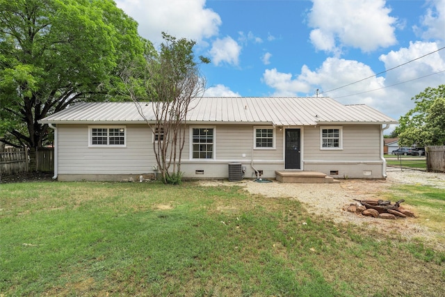 738 Randy Dr, Woodway, TX 76712 - back of house featuring metal roof, crawl space, central air condition unit, and a fire pit