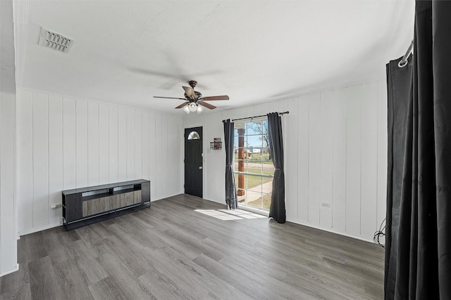 738 Randy Dr, Woodway, TX 76712 - unfurnished living room with a ceiling fan and wood finished floors