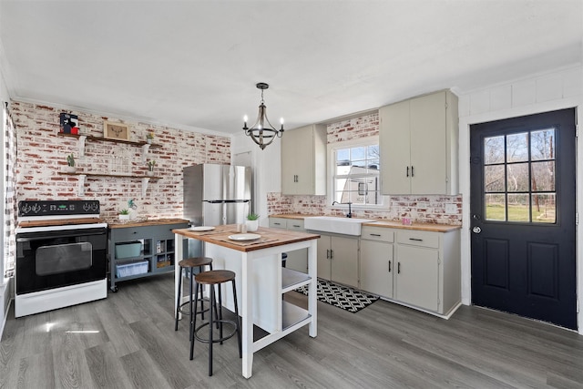 738 Randy Dr, Woodway, TX 76712 - kitchen featuring electric range oven, butcher block counters, a sink, open shelves, and a chandelier