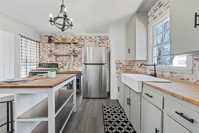 738 Randy Dr, Woodway, TX 76712 - kitchen featuring freestanding refrigerator, open shelves, wooden counters, a sink, and light wood finished floors