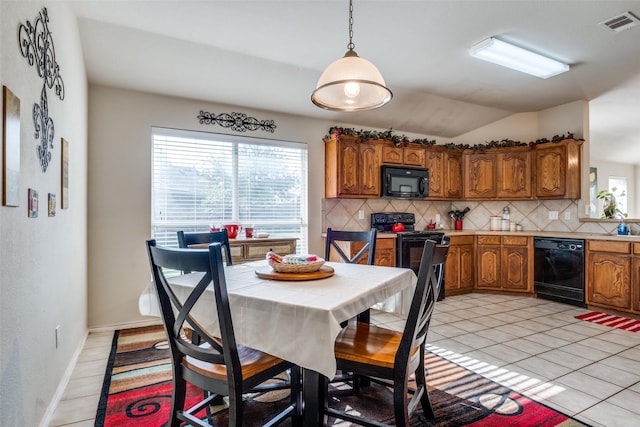 2101 Thistle Ln, Forney, TX 75126 - kitchen featuring black appliances, tasteful backsplash, brown cabinetry, light tile patterned floors, and plenty of natural light