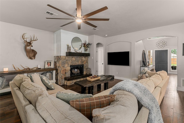 3659 Smoketree Dr, Rockwall, TX 75032 - living room with arched walkways, a ceiling fan, wood-type flooring, and a fireplace