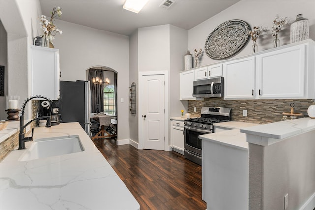 3659 Smoketree Dr, Rockwall, TX 75032 - kitchen featuring stainless steel appliances, dark wood finished floors, light stone counters, decorative backsplash, and white cabinetry