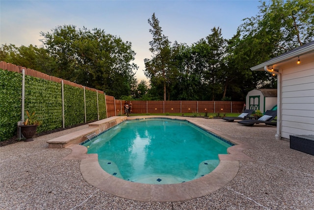3659 Smoketree Dr, Rockwall, TX 75032 - pool at dusk with a shed, a fenced backyard, and a patio