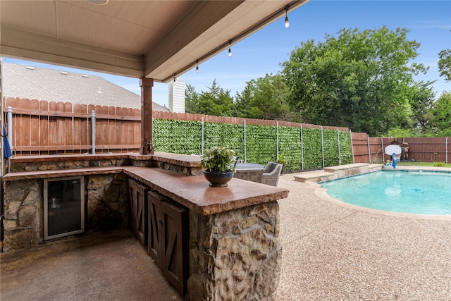 3659 Smoketree Dr, Rockwall, TX 75032 - view of pool with an outdoor kitchen, a fenced backyard, and a patio