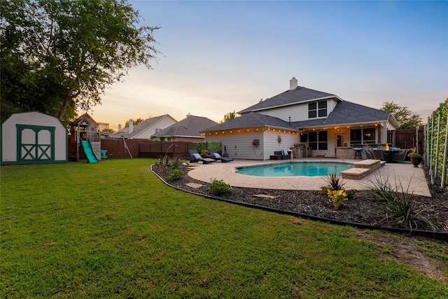 3659 Smoketree Dr, Rockwall, TX 75032 - view of swimming pool with a storage unit, a fenced backyard, a patio, and a playground