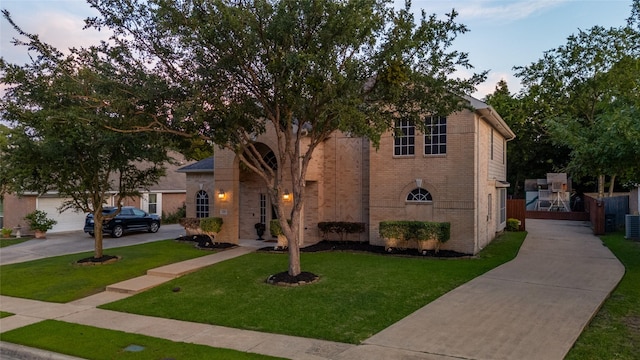 3659 Smoketree Dr, Rockwall, TX 75032 - view of front of home featuring concrete driveway, brick siding, and a lawn