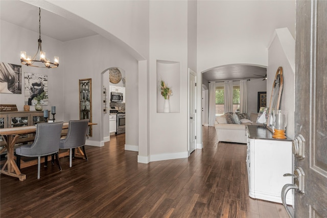 3659 Smoketree Dr, Rockwall, TX 75032 - foyer entrance with arched walkways, dark wood-style floors, a chandelier, and a high ceiling