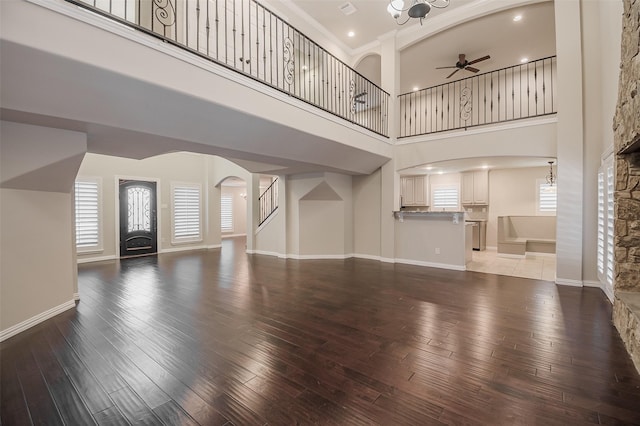 3313 Country Club Rd, Pantego, TX 76013 - unfurnished living room with ceiling fan, hardwood / wood-style flooring, arched walkways, a high ceiling, and recessed lighting
