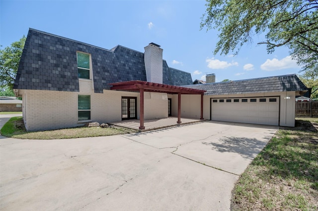 3313 Country Club Rd, Pantego, TX 76013 - view of front of home with a garage, brick siding, mansard roof, and concrete driveway