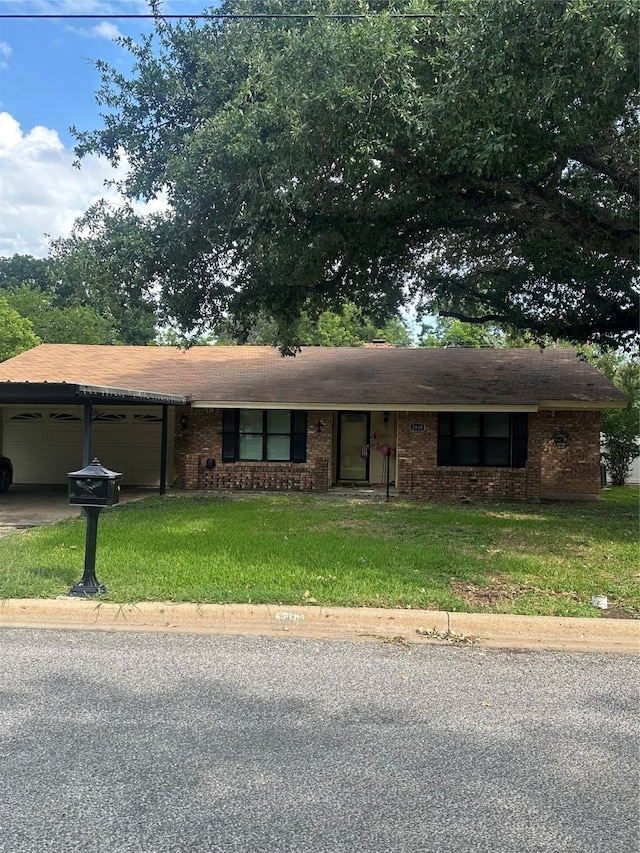 2410 Asbury St, Brownwood, TX 76801 - ranch-style home with an attached garage, a front yard, concrete driveway, and brick siding