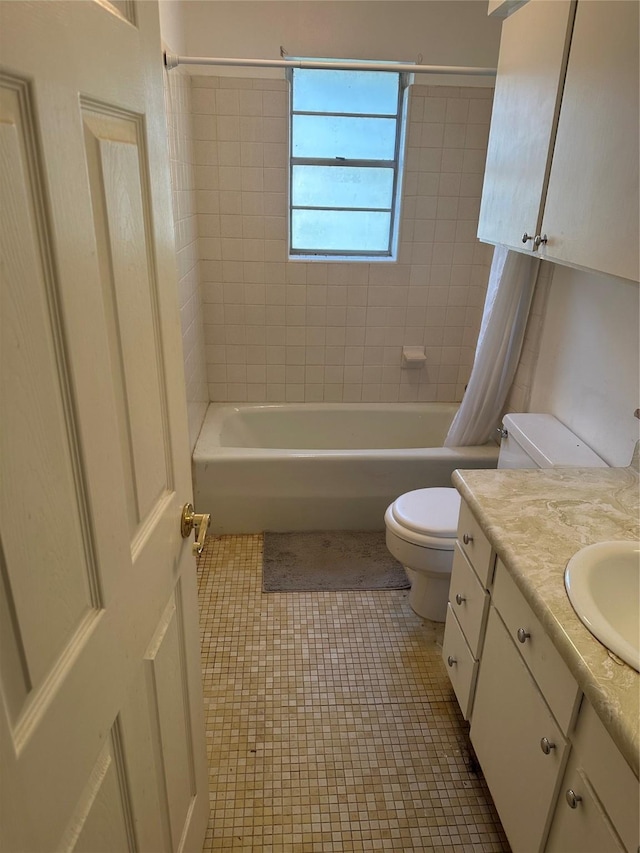 2410 Asbury St, Brownwood, TX 76801 - full bath featuring toilet, shower / bath combo with shower curtain, vanity, and tile patterned floors