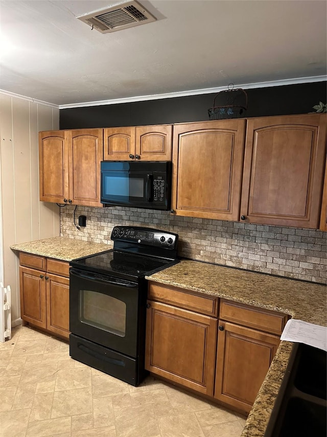 2410 Asbury St, Brownwood, TX 76801 - kitchen with black appliances, backsplash, brown cabinets, stone counters, and crown molding