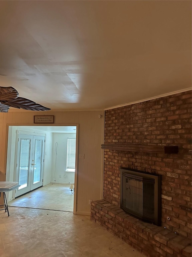 2410 Asbury St, Brownwood, TX 76801 - unfurnished living room with a fireplace and wood walls