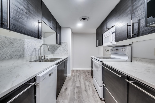 576 E Ave J Unit B, Grand Prairie, TX 75050 - kitchen with white appliances, a sink, backsplash, and dark cabinets