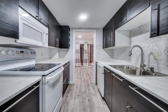 576 E Ave J Unit B, Grand Prairie, TX 75050 - kitchen featuring white appliances, a sink, light wood finished floors, tasteful backsplash, and dark cabinets