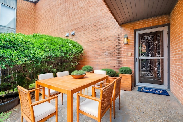 576 E Ave J Unit B, Grand Prairie, TX 75050 - entrance to property featuring outdoor dining area, brick siding, and a patio