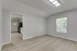 128 Stephens St, Waxahachie, TX 75165 - empty room featuring vaulted ceiling, light wood finished floors, and baseboards