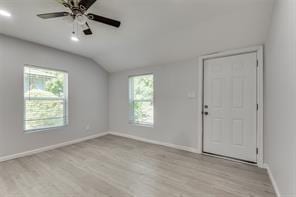 128 Stephens St, Waxahachie, TX 75165 - unfurnished room featuring lofted ceiling, wood finished floors, baseboards, and plenty of natural light
