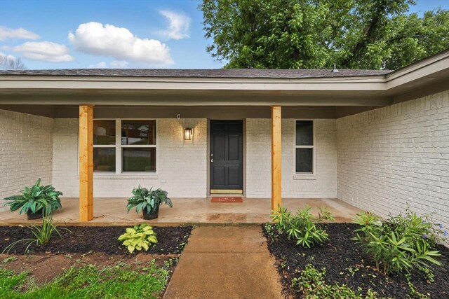 6304 Circleview Dr, Haltom City, TX 76180 - view of exterior entry with a porch and brick siding