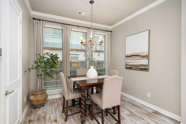 1229 Comanche Dr, Allen, TX 75013 - dining area with a chandelier, light wood-type flooring, and crown molding