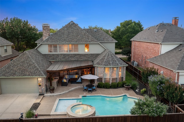 1229 Comanche Dr, Allen, TX 75013 - rear view of house featuring a shingled roof, a chimney, a patio area, an attached garage, and concrete driveway