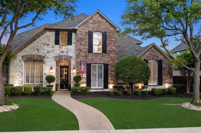 1229 Comanche Dr, Allen, TX 75013 - view of front of home with brick siding, a shingled roof, a front lawn, and stone siding