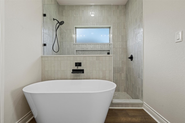 10917 Granada Dr, Waco, TX 76708 - full bath with a freestanding tub, walk in shower, and wood finished floors