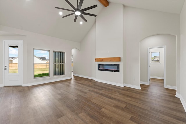 10917 Granada Dr, Waco, TX 76708 - unfurnished living room with a ceiling fan, high vaulted ceiling, arched walkways, a glass covered fireplace, and beam ceiling