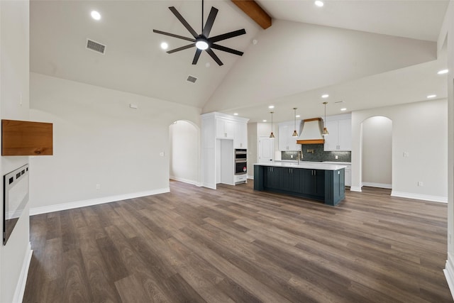 10917 Granada Dr, Waco, TX 76708 - kitchen featuring arched walkways, open floor plan, ceiling fan, beam ceiling, and light countertops
