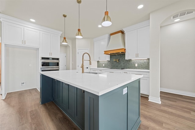 10917 Granada Dr, Waco, TX 76708 - kitchen featuring custom exhaust hood, white cabinets, a sink, decorative backsplash, and recessed lighting