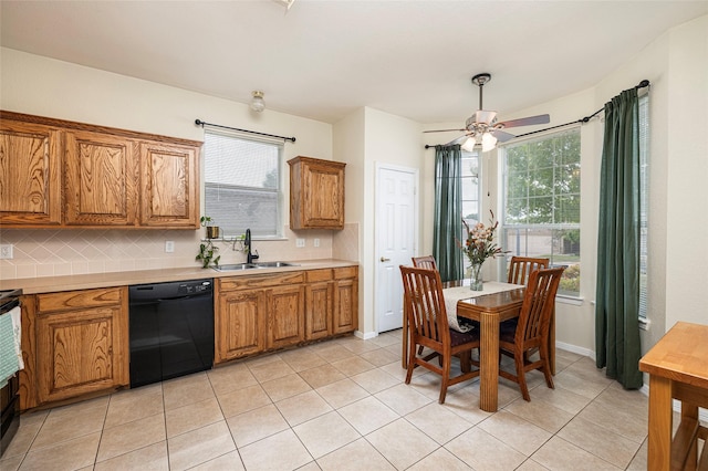 10325 Hogan Dr, Benbrook, TX 76126 - kitchen with black dishwasher, a sink, brown cabinetry, and backsplash