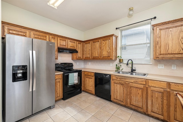 10325 Hogan Dr, Benbrook, TX 76126 - kitchen with black appliances, a sink, under cabinet range hood, brown cabinetry, and decorative backsplash