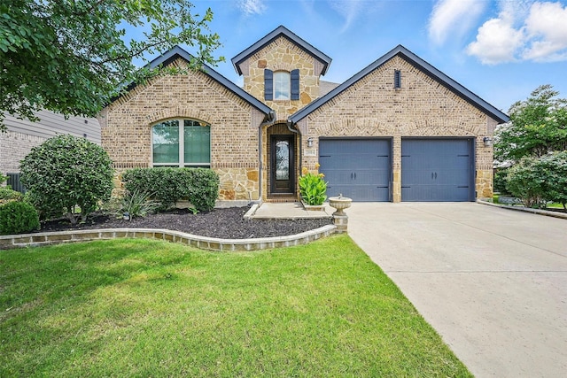 2004 Long Park Ave, Prosper, TX 75078 - french provincial home featuring stone siding, an attached garage, concrete driveway, and a front lawn