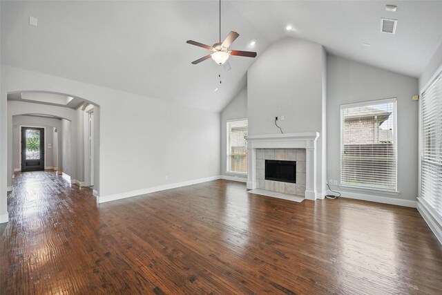 2004 Long Park Ave, Prosper, TX 75078 - unfurnished living room with a ceiling fan, a fireplace, high vaulted ceiling, arched walkways, and wood finished floors