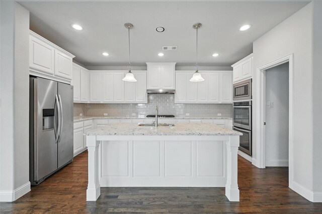 2004 Long Park Ave, Prosper, TX 75078 - kitchen featuring appliances with stainless steel finishes, a sink, a center island with sink, white cabinets, and decorative backsplash