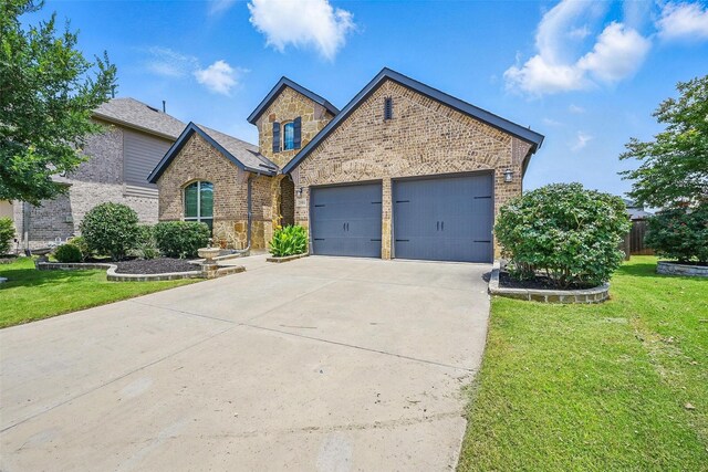 2004 Long Park Ave, Prosper, TX 75078 - view of front of house featuring brick siding, a front yard, driveway, and an attached garage