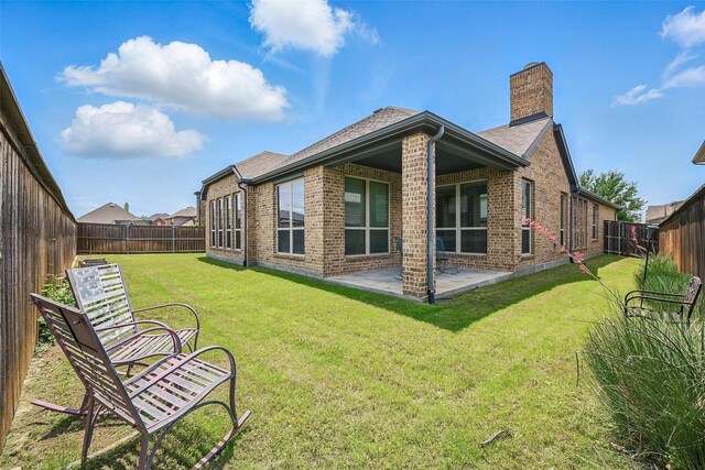 2004 Long Park Ave, Prosper, TX 75078 - back of house with brick siding, a chimney, a patio area, and roof with shingles