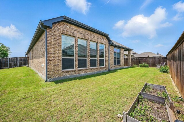 2004 Long Park Ave, Prosper, TX 75078 - back of property featuring a garden and brick siding