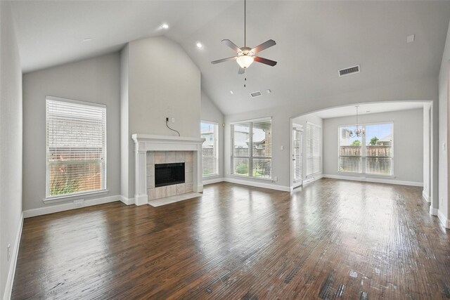 2004 Long Park Ave, Prosper, TX 75078 - unfurnished living room with a tiled fireplace, plenty of natural light, ceiling fan, a chandelier, and high vaulted ceiling