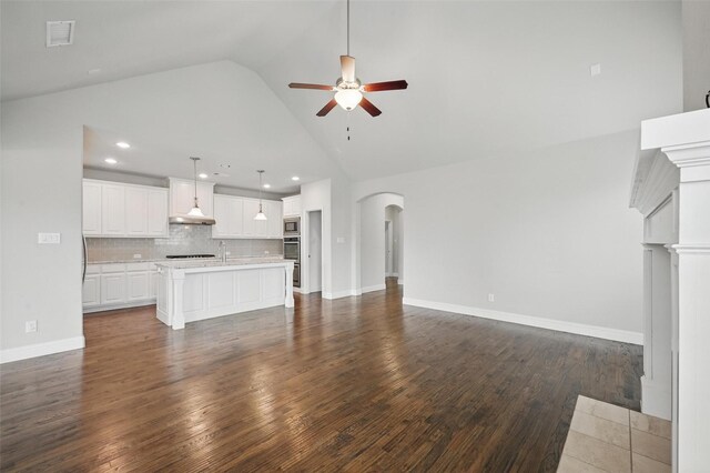 2004 Long Park Ave, Prosper, TX 75078 - unfurnished living room with a ceiling fan, arched walkways, high vaulted ceiling, dark wood-style floors, and recessed lighting