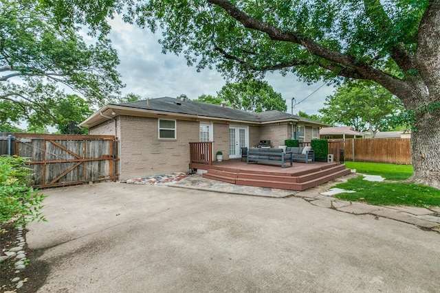 605 Devonshire Dr, Richardson, TX 75080 - back of property featuring brick siding, a deck, a patio area, french doors, and outdoor lounge area