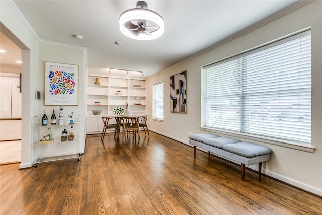 605 Devonshire Dr, Richardson, TX 75080 - dining area featuring ornamental molding, wood finished floors, and baseboards