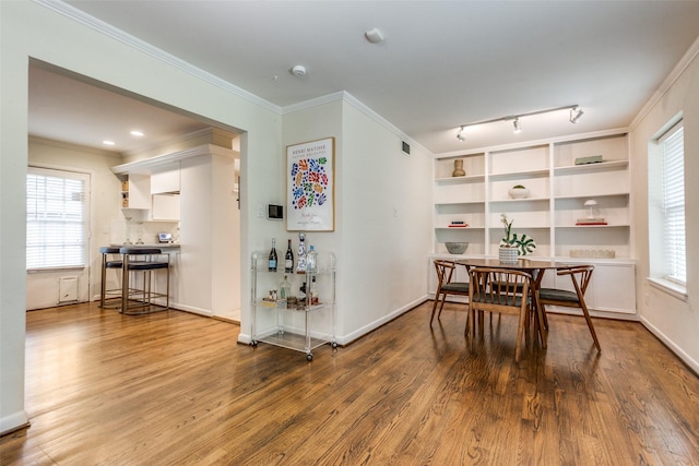 605 Devonshire Dr, Richardson, TX 75080 - dining space with wood finished floors, crown molding, and baseboards