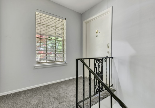 7718 Royal Ln Unit 214, Dallas, TX 75230 - hallway featuring an upstairs landing, carpet flooring, and baseboards