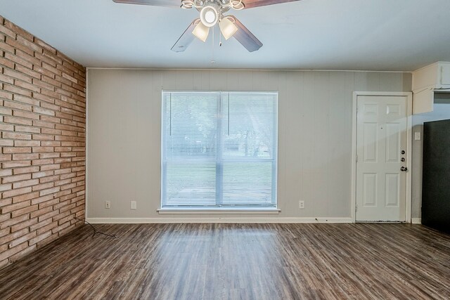5729 Wales Ave, Fort Worth, TX 76133 - spare room featuring brick wall, ceiling fan, wood finished floors, and baseboards