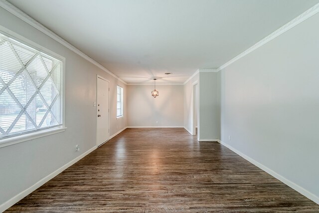 5729 Wales Ave, Fort Worth, TX 76133 - empty room with dark wood-style flooring, baseboards, crown molding, and a chandelier